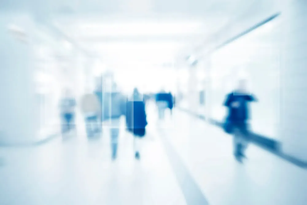 Blurry image of people walking down the street as seen through fictional facial recognition software
